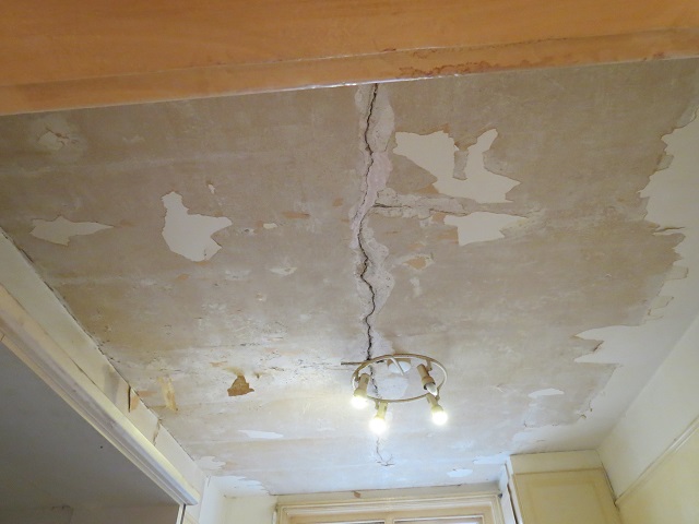 Andrew Gard stripping ceiling paper ready for repapering