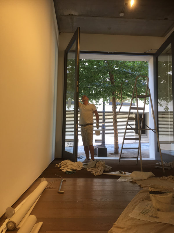 London painter and decorator painting large doors