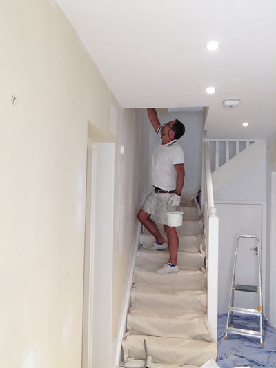 Painting a stairway in a Central London clinic, in Marylebone. Dustsheets down and white emulsion on walls and ceiling