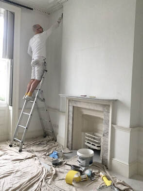 London Painters painting in central London. Painting a lounge standing on a ladder 
