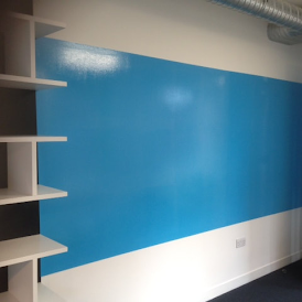 Dry erase white board painted blue on a wall